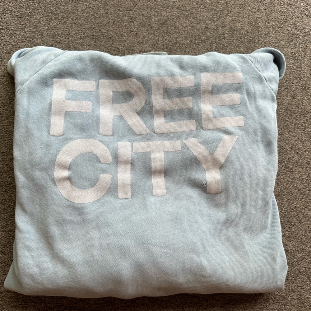 Free city Sweatshirt some small holes by front pouch. Fair condition